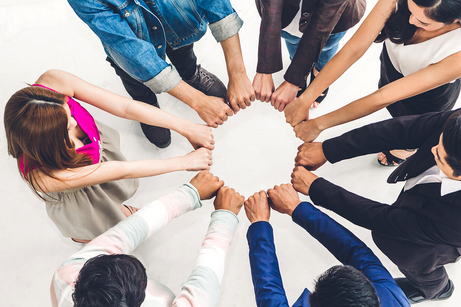 teamwork - group of adults making circle with hands
