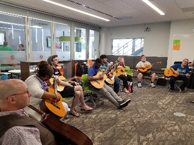 Teachers playing guitars together